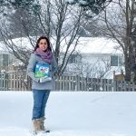 Dr. Sandy Moniz holds her novel, Jacob's Journey: The Boy Born Early